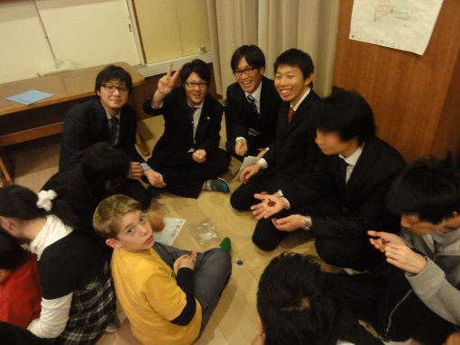 Bailey shows the teens how to spin the dreidel.