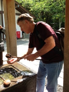 Dr. Roger Spott respectfully washes his hands before entering the shrine